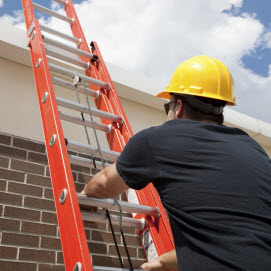 Worker climbing ladder