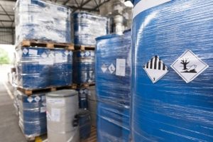 Waste barrels with hazard warning symbols in the warehouse